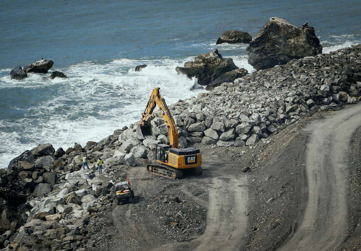 In a March. 8, 2018 photo, crews work to finish up the massive seawall at the base of the Mud Creek Slide on the Big Sur Coast of Calif. Highway 1 has been dogged by slides since December 2016, but the one that hit at Mud Creek near Ragged Point in May 2017 was monumental. (Joe Johnston /The Tribune (of San Luis Obispo) via AP)