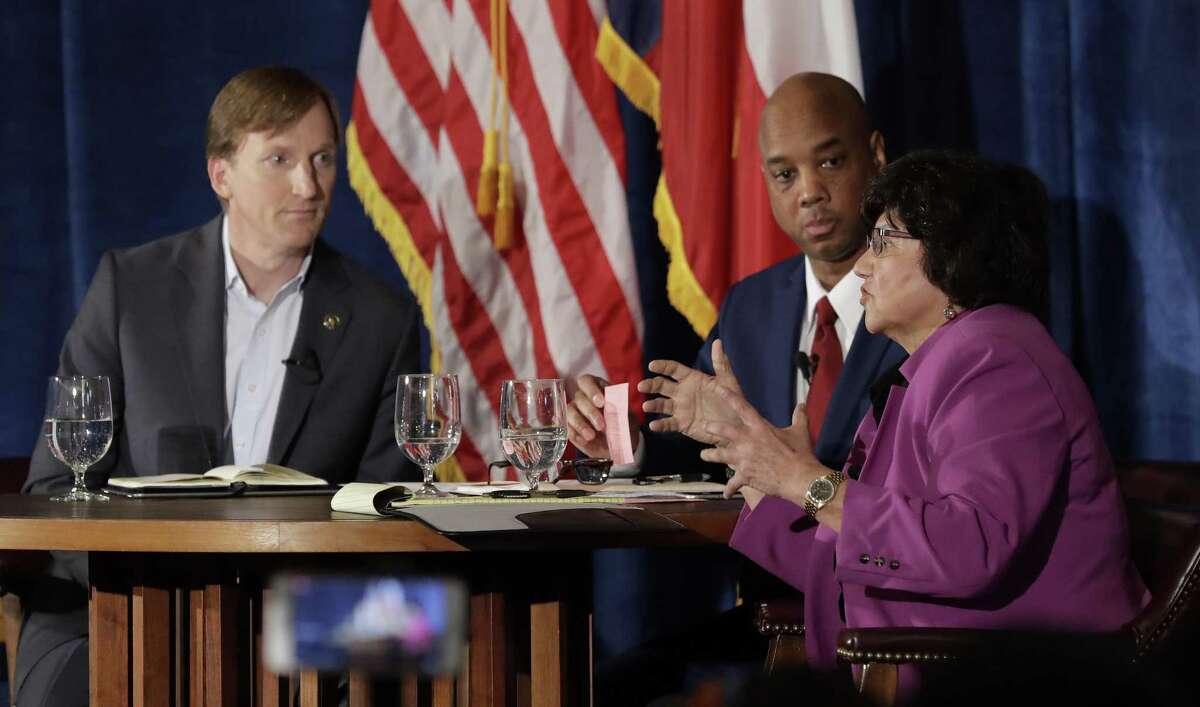 Texas Democratic gubernatorial candidates Andrew White, left, and Lupe Valdez, right, take part in a debate, Friday, May 11, 2018, in Austin, Texas, ahead of the state's May 22 primary runoff election. Moderator Gromer Jeffers is at center. (AP Photo/Eric Gay)