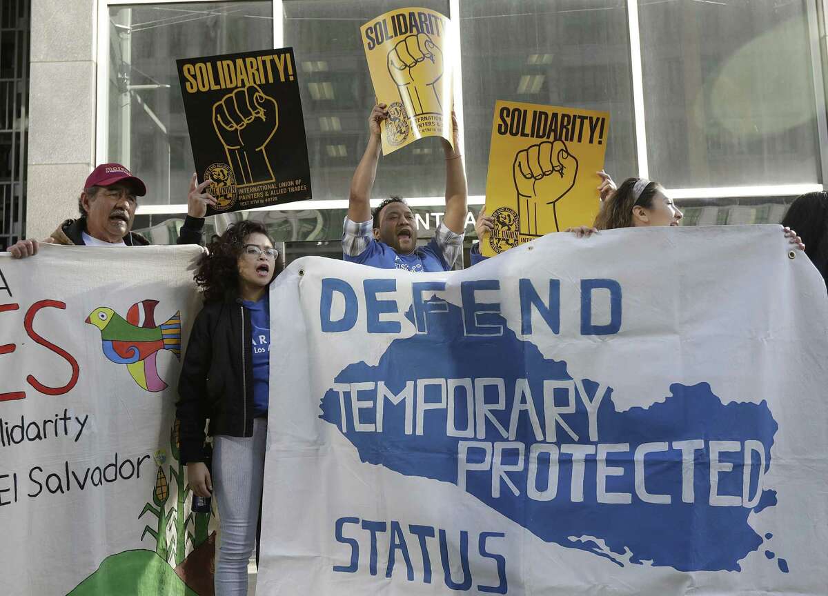 Supporters of temporary protected status immigrants hold signs and cheer at a rally before a news conference announcing a lawsuit against the Trump administration over its decision to end a program that lets immigrants live and work legally in the United States outside of a federal courthouse in San Francisco, Monday, March 12, 2018. Plaintiffs are alleging the decision to end temporary protected status for El Salvador, Haiti, Nicaragua and Sudan was racially motivated.