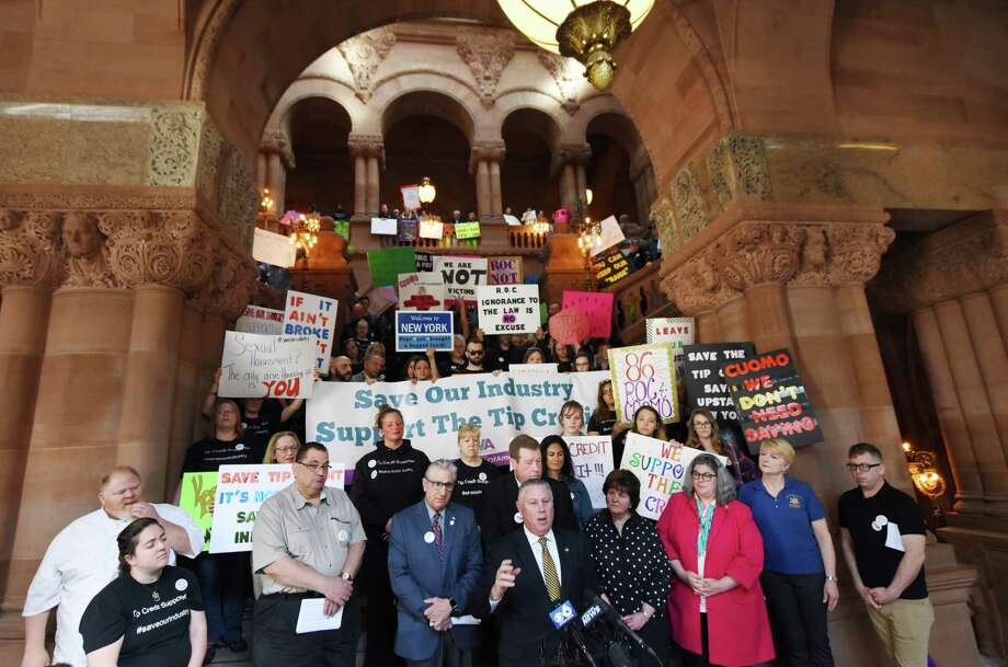 Assemblyman John T. McDonald III, center, speaks during a rally and press conference to demonstrate against a proposed plan to eliminate the stateÕs tip credit on Friday, May 18, 2018, in Albany, N.Y. Tip credit is the amount between what a tipped employee makes and what the established minimum wage is. Gov. Andrew Cuomo directed the Commissioner of Labor to set up public hearings to look at the possibility of eliminating minimum wage tip credits across the state. (Will Waldron/Times Union) Photo: Will Waldron, Albany Times Union / 20043817A