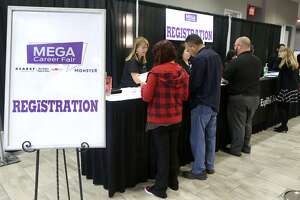 People register Wednesday February 21, 2018 at the Mega Career Fair at the Norris Conference Center on Loop 410. Twenty six companies were represented at the event offering employment in manufacturing, transportation, healthcare and more.