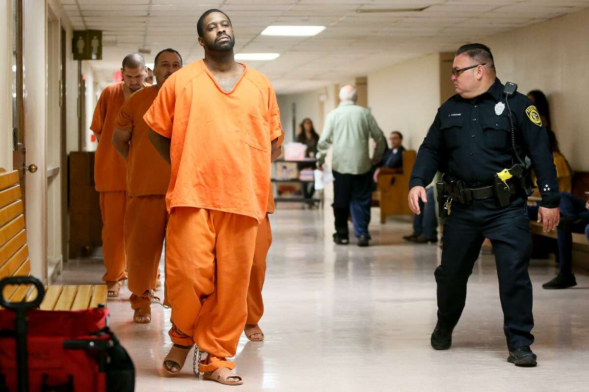 Deandre Dorch (front left) is led toward the Felony Impact Court, presided by Judge Laura Parker, in the Bexar County Courthouse for sentincing on Friday, May 18, 2018. Dorch, convicted of injury to a child by omission and abandonment of a child in the horrific case of two children who were tied up like dogs and left in the backyard of a home in Northeast Bexar County, received a sentence of 65 years in jail but will be eligible for parole in 30 years. MARVIN PFEIFFER/mpfeiffer@express-news.net