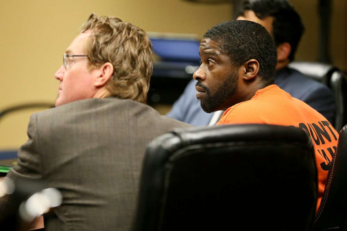 Deandre Dorch appears with defense attorney Edward Bravenec (left) and co-counsel Patrick Lamas for sentencing in the Felony Impact Court, presided by Judge Laura Parker, in the Bexar County Courthouse on Friday, May 18, 2018. Dorch, convicted of injury to a child by omission and abandonment of a child in the horrific case of two children who were tied up like dogs and left in the backyard of a home in Northeast Bexar County, received a sentence of 65 years in jail but will be eligible for parole in 30 years. MARVIN PFEIFFER/mpfeiffer@express-news.net