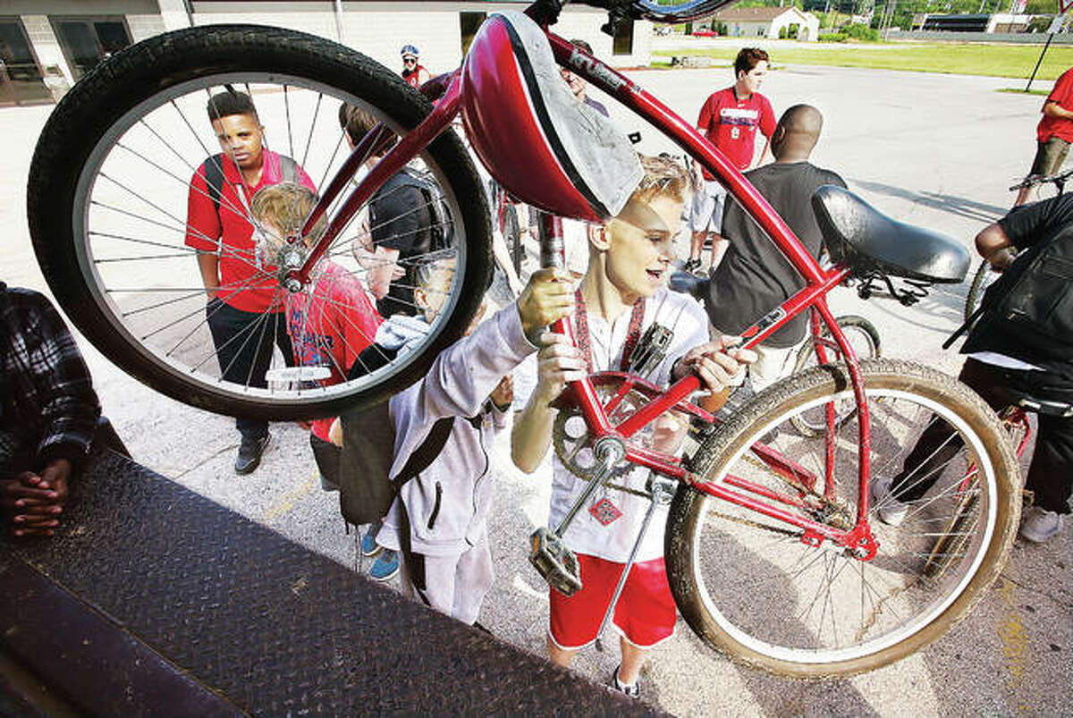 Alton Middle School students unload bicycles Wednesday morning in front of the East Alton Ice Arena for a 14-mile bicycle ride.