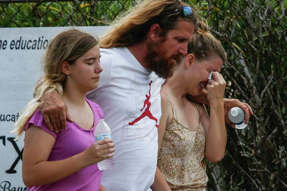 A woman is comforted as she wipes away tears after walking out of the Barnett Intermediate School where parents gathered as they waited to hear from their children after a mass shooting at Santa Fe High School Friday, May 18, 2018 in Santa Fe. Photo: Michael Ciaglo, Houston Chronicle / Michael Ciaglo