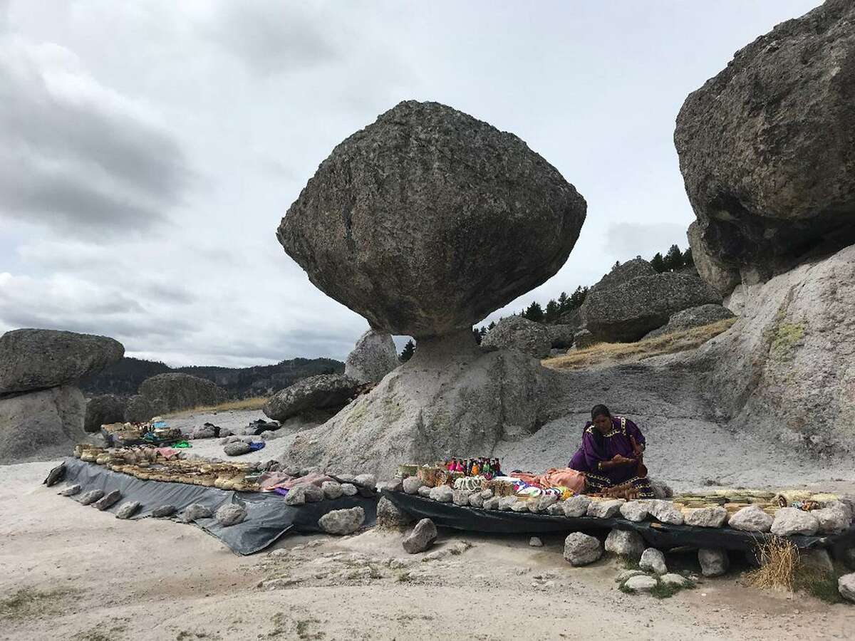 A Tarahumara women sells arts and crafts alongside volcanic rock formations near Creel, Mexico.