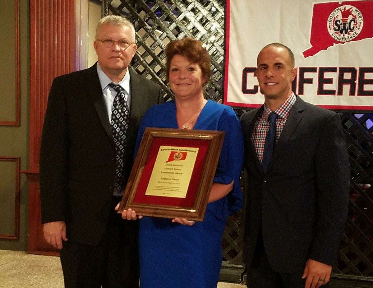 Kathleen Davey of Newtown High School, center, was presented with the David Johnson Unified Sports Leadership Award by SWC Commissioner David Johnson, left, and Newtown High Athletic Director Matt Memoli at the South-West Conference’s annual leadership banquet, held at The Amber Room in Danbury on May 3.