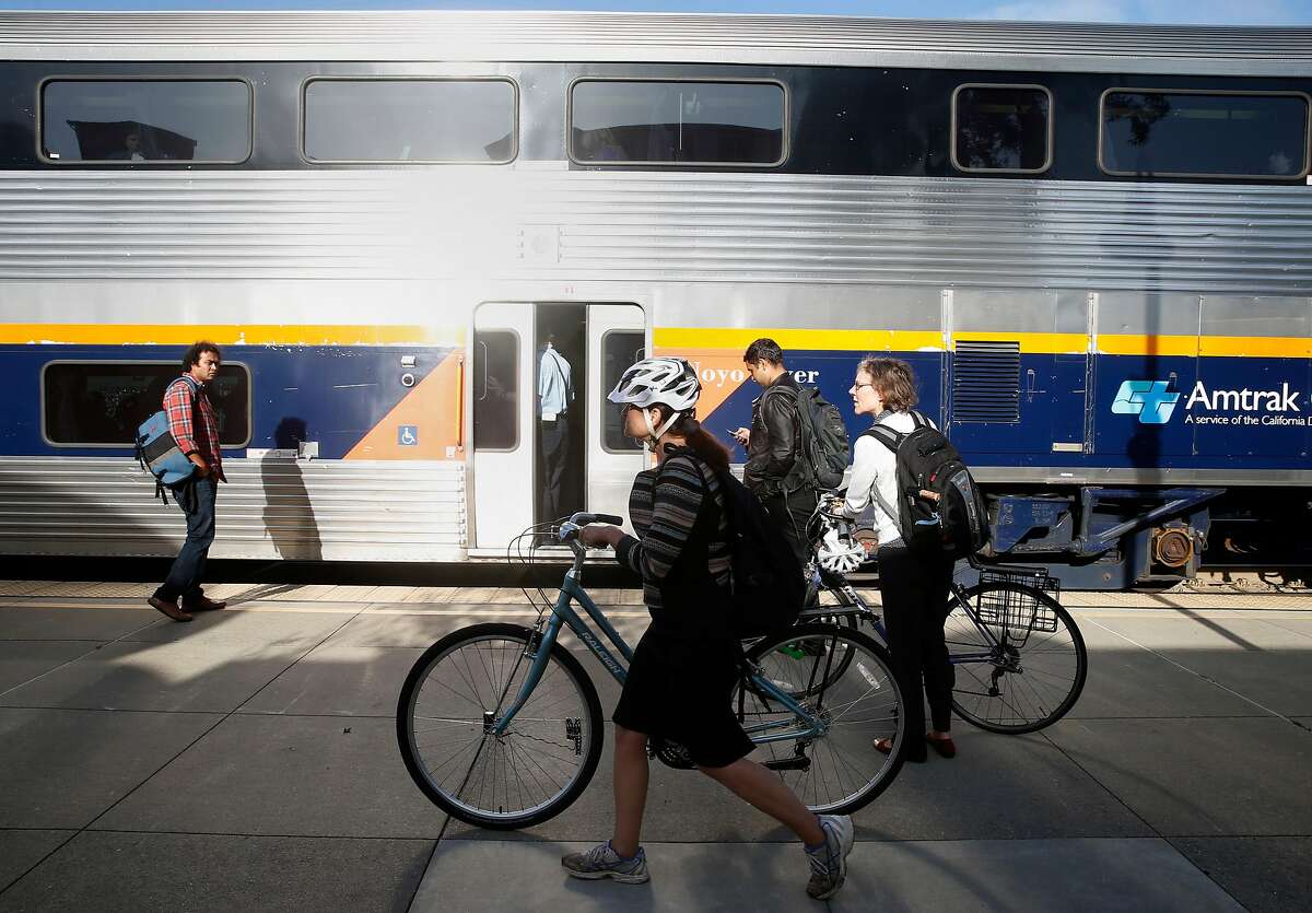 Commuters prepare to board a westbound Capitol Corridor train at the Amtrak station in Berkeley, Calif. on Thursday, May 10, 2018. Improvements to the Capitol Corridor's infrastructure would be upgraded if voters approve Regional Measure 3 which would raise area bridge tolls, except on the Golden Gate Bridge, which would fund transportation projects throughout the Bay Area.