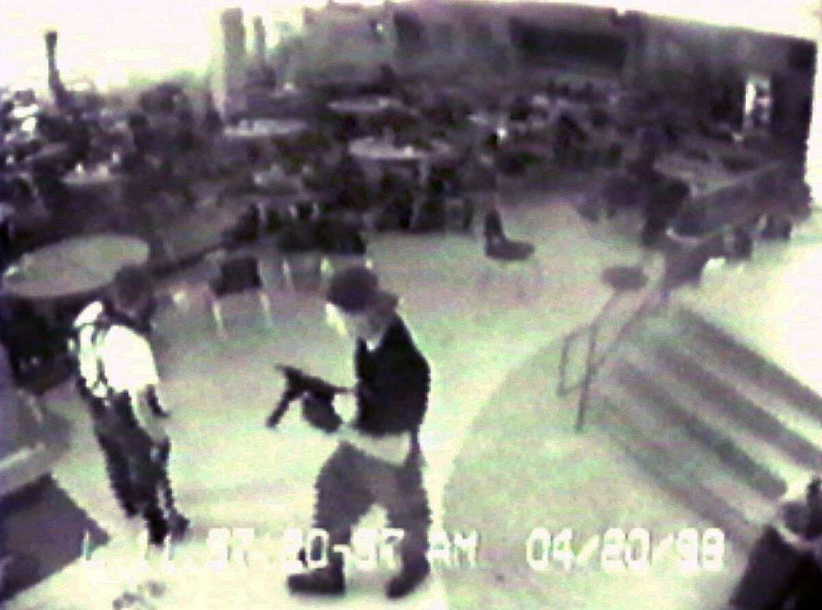 In this April 20, 1999 file photo Eric Harris, left, and Dylan Klebold, carrying a TEC-9 semi-automatic pistol, are seen in a photo made from a security camera image in the cafeteria at Columbine High School, in Littleton, Colo., during their shooting rampage which killed a teacher and 12 students. The mother of Columbine killer Dylan Klebold says she has been studying suicide in the decade since the high school massacre but had no idea her son was suicidal until she read his journals after his death. (AP Photo/Jefferson County Sheriff's Department/File)