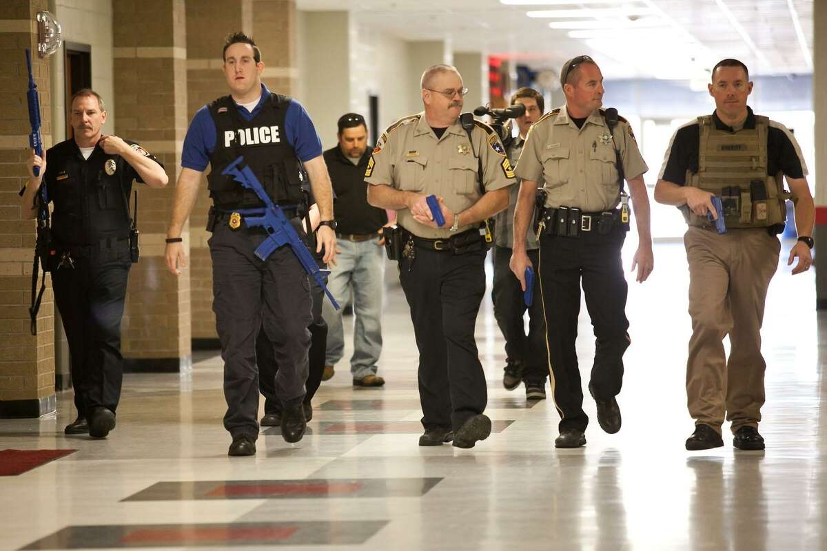 Law enforcement officers participated in an active shooter training session held at Cleveland High School on Friday, March 15. Organized by Cleveland ISD Police Chief Rex Evans, a week of classes ended with an actual drill Friday morning. The purpose of the drill is to show areas where improvement is needed in the event of a real school shooter situation. Pictured left to right are Cleveland ISD Officer John Shannon, Cleveland PD Sgt. Jake Ladwig, Liberty County Sheriff's Sgt. Floyd "Bubba" Pearson, Liberty County Sheriff's Deputy James McQueen and Liberty County Sheriff's Investigator Brian Bortz.