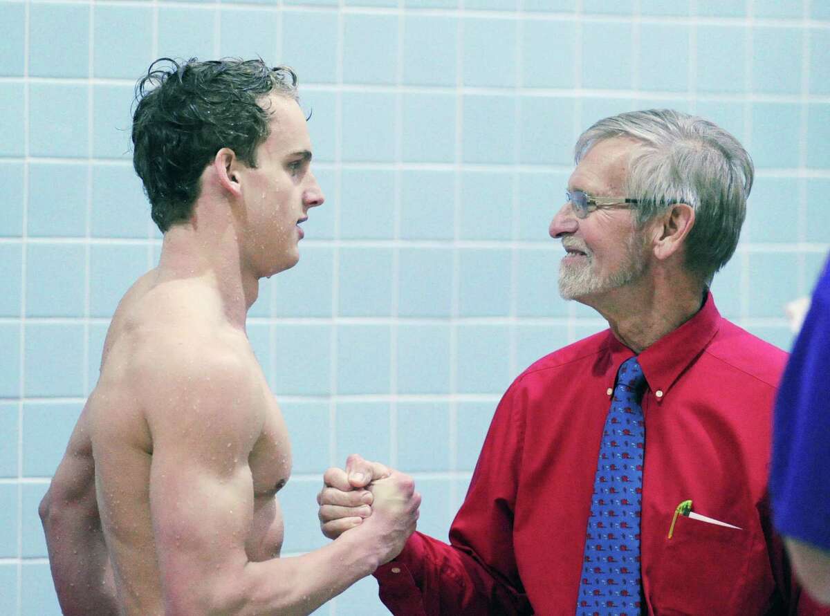 GHS swimming coach Terry Lowe, at right, congratulates Jack Montesi after Montesi won the 100 yard backstroke event during the 2016 CIAC boys class LL swimming championships. If the Junior League of Greenwich has its way the new municipal pool in Byram will be named in honor of Lowe, a hall of fame coach.