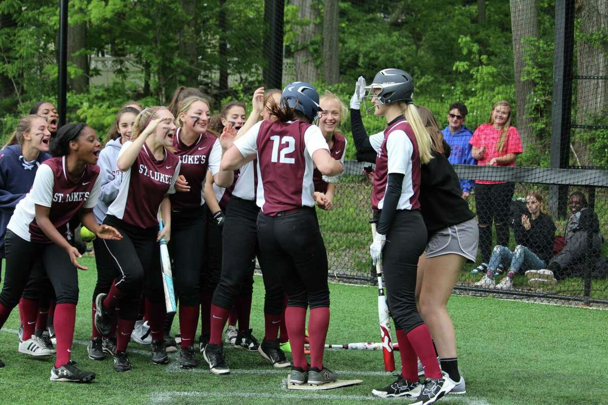 St. Luke's Riley Page jumps on home plate after a home run during the FAA softball championship between St. Luke's and Hopkins at St. Luke's School in New Canaan, Conn on May 18, 2018. St. Luke's claimed its fourth-straight title 11-2.