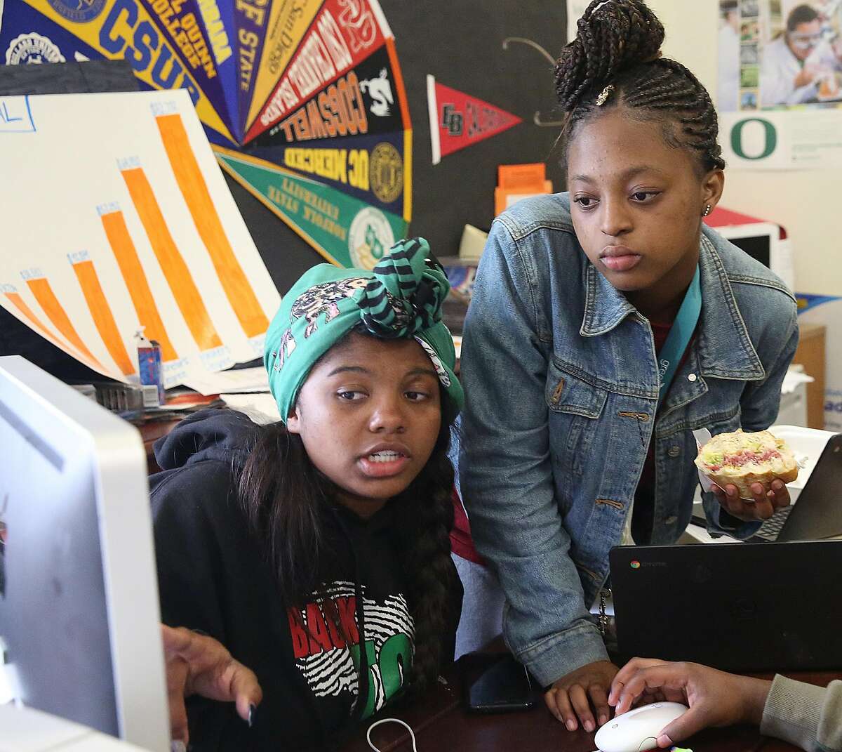 Senior Destiny Shabazz (left) talks with Brooke-Lynn Upshur (right) in the college and career center at McClymonds High School on Friday, May 18, 2018 in Oakland, Calif.