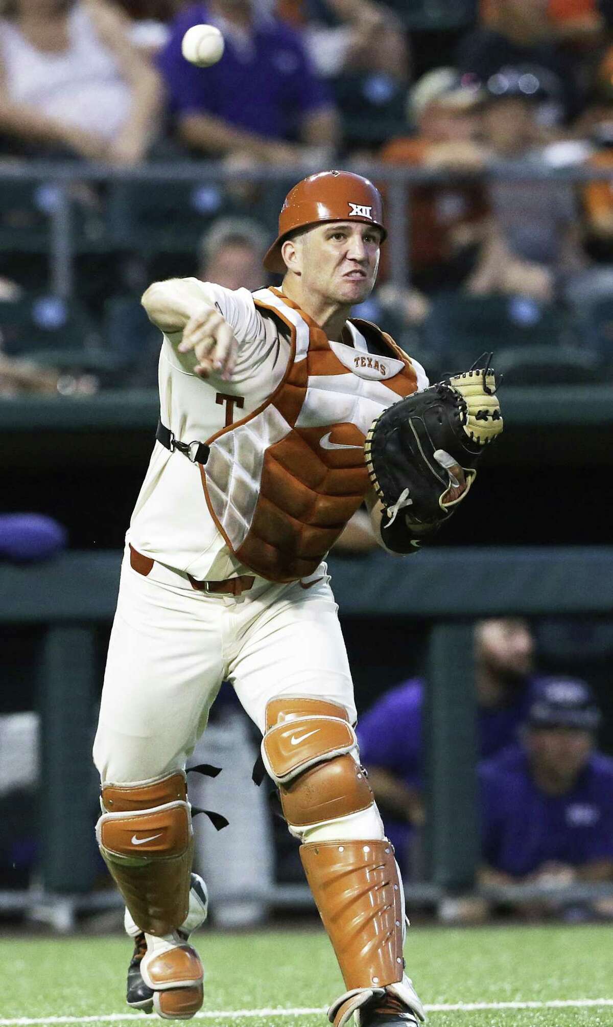 Longhorn catcher DJ Petrinsky throws out a runner at first on a bunt try as UT hosts TCU in men's baseball at Disch-Falk Field on May 18, 2018.
