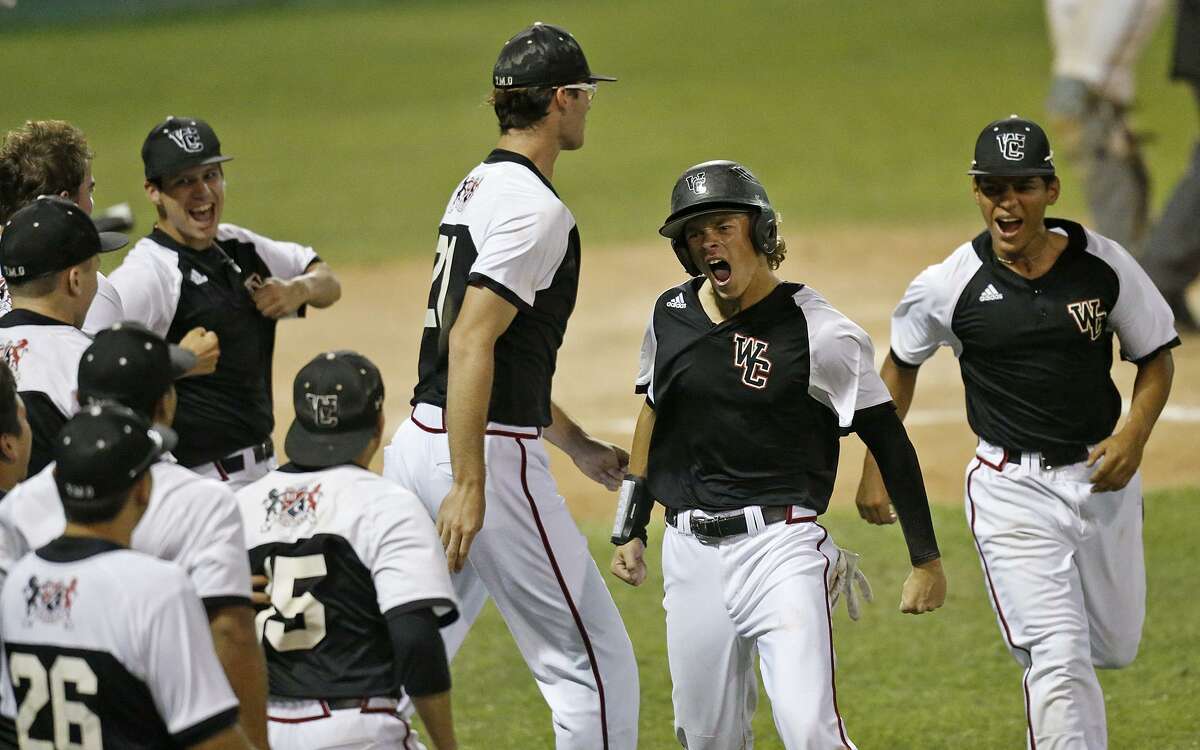 Churchill's Hudson Head (center) celebrates with teammates after scoring against Madison during game 2 of their Class 6A third-round playoff series held Friday May 18, 2018 at Blossom Athletic Center.