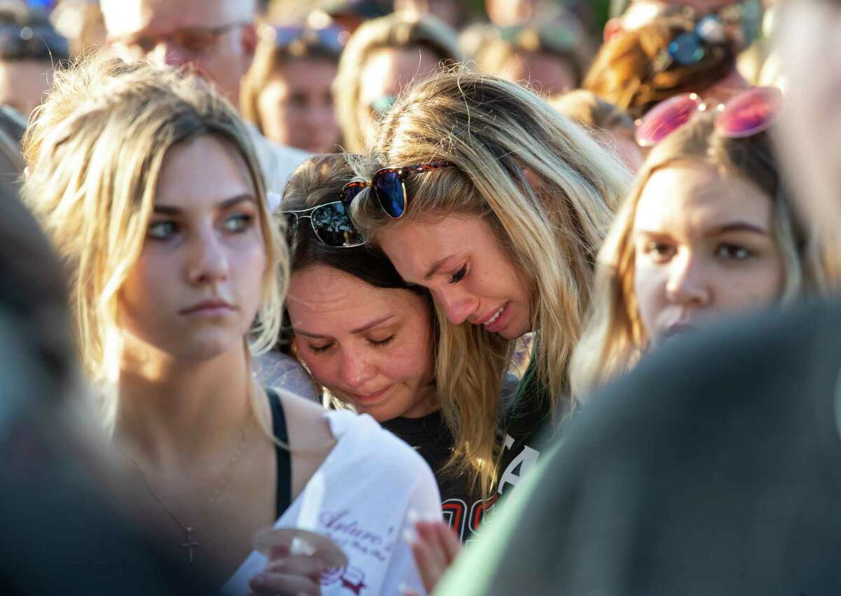Women embrace during a prayer vigil following a shooting at Santa Fe High School in Santa Fe, Texas, on Friday, May 18, 2018. Seventeen-year-old Dimitrios Pagourtzis is charged with capital murder in the deadly shooting rampage. (Stuart Villanueva The Galveston County Daily News via AP)