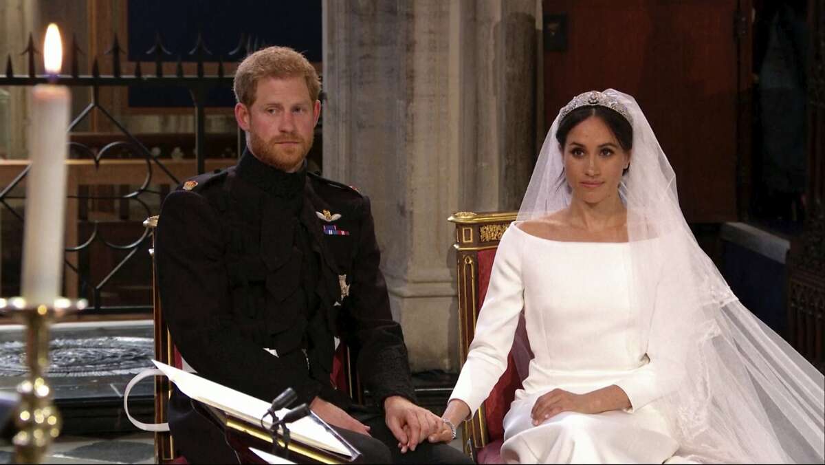 In this frame from video, Britain's Prince Harry and Meghan Markle listen at their wedding ceremony at St. George's Chapel in Windsor Castle in Windsor, near London, England, Saturday, May 19, 2018. (UK Pool/Sky News via AP)