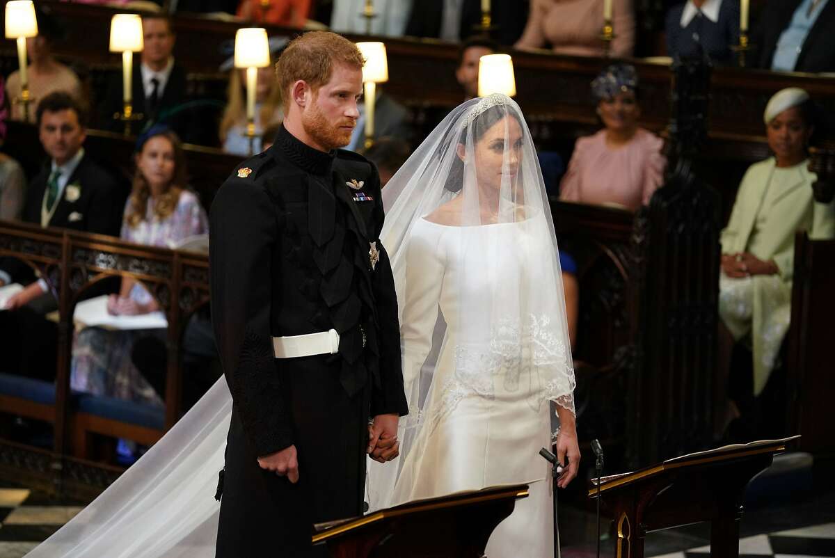 WINDSOR, UNITED KINGDOM - MAY 19: Prince Harry and Meghan Markle stand together in St George's Chapel at Windsor Castle for their wedding on May 19, 2018 in Windsor, England. (Photo by Dominic Lipinski - WPA Pool/Getty Images)