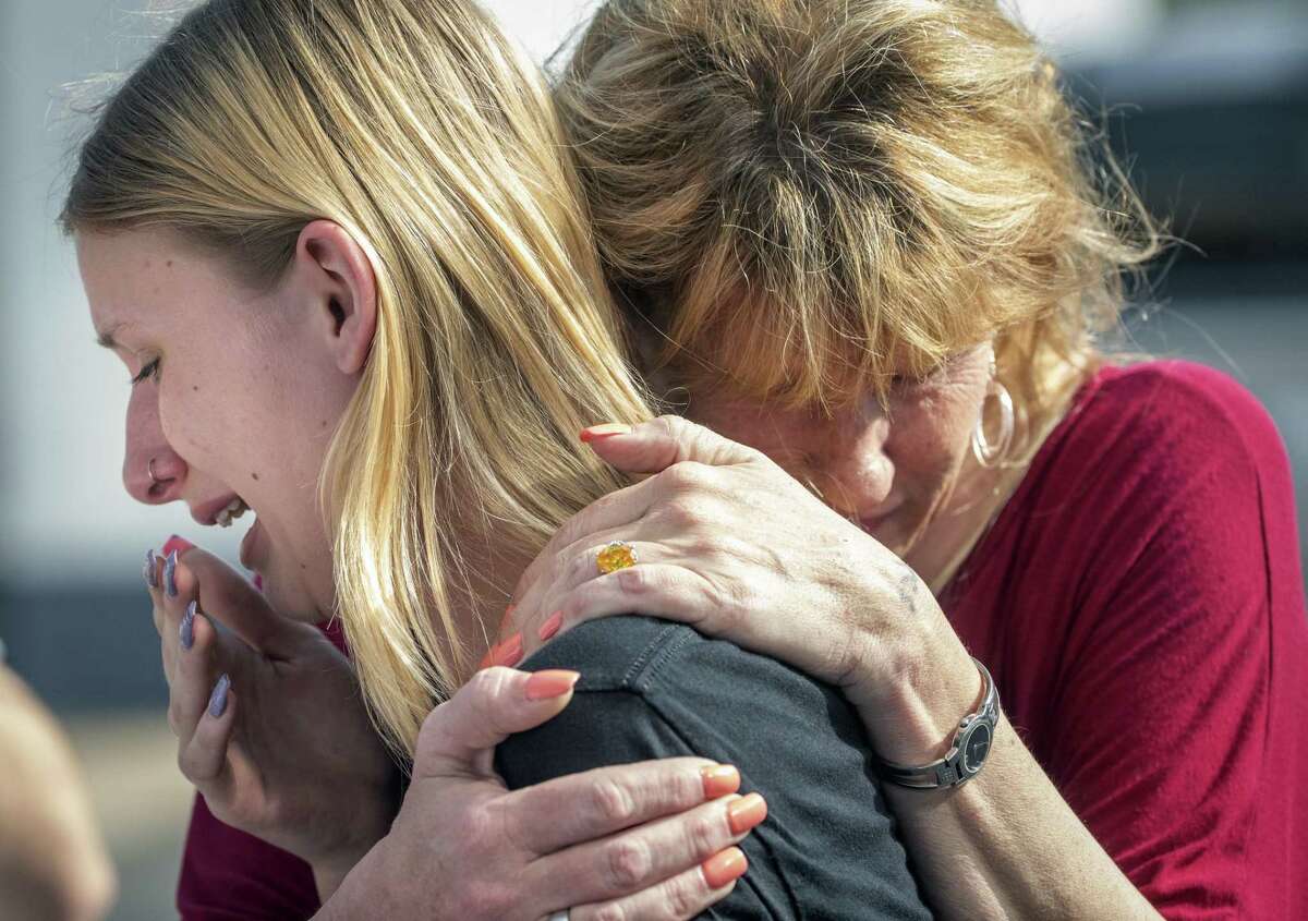Santa Fe High School student Dakota Shrader is comforted by her mother Susan Davidson following a shooting at the school on Friday, May 18, 2018, in Santa Fe, Texas. Shrader said her friend was shot in the incident. (Stuart Villanueva/The Galveston County Daily News via AP)