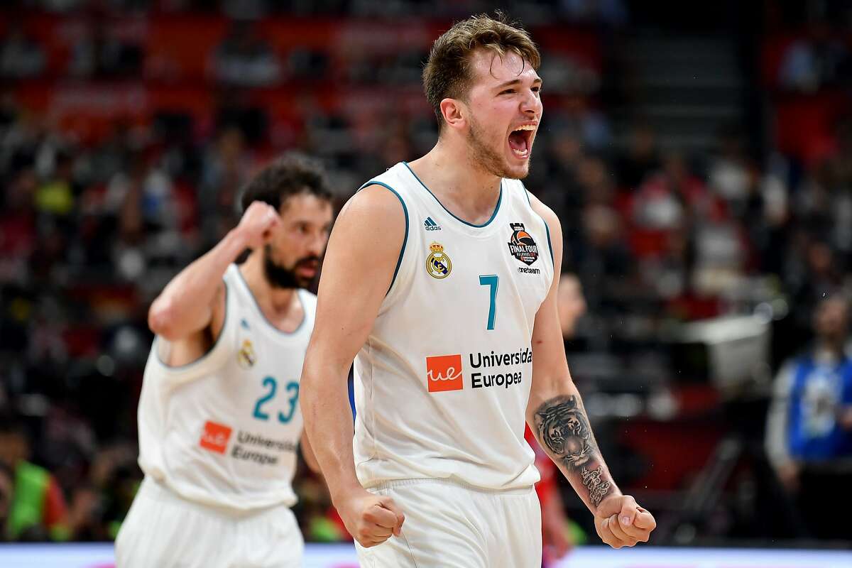 TOPSHOT - Real Madrid's Slovenian Luka Doncic (R) and Real Madrid's Spanish guard Sergio Llull react after scoring a point during the Euroleague Final Four second semi-final match between CSKA Moscow and Real Madrid at The Stark Arena in Belgrade on May 18, 2018. / AFP PHOTO / ANDREJ ISAKOVICANDREJ ISAKOVIC/AFP/Getty Images