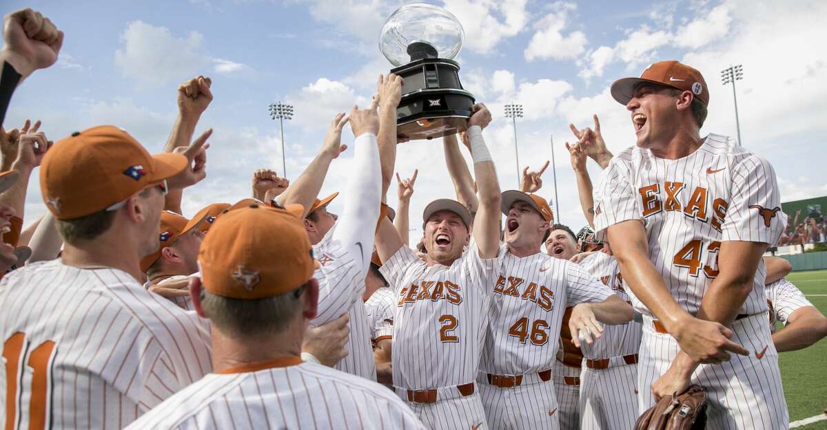 Texas' Kody Clemens (2) and Brandon Ivey (46) hoist the Big 12 championship trophy after Texas defeated TCU in a college baseball game Saturday, May 19, 2018, in Austin, Texas. (Jay Janner/Austin American-Statesman via AP)