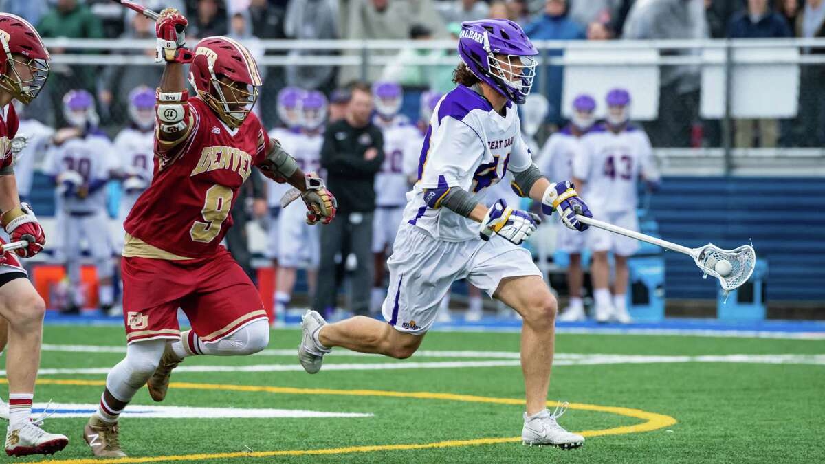 UAlbany's Kyle McClancy sprints past Denver's Trevor Baptiste on his way to a goal. The Great Danes defeated the Pioneers 15-13 on Saturday, May 19, 2018, to advance to next weekend's Final Four in Foxborough, Mass. (Bill Ziskin / UAlbany Athletics)