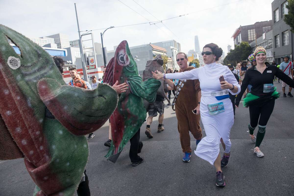 Princess Leia high-fives the spawning fish during the 2018 Bay to Breakers on Howard Street on May 20, 2018.