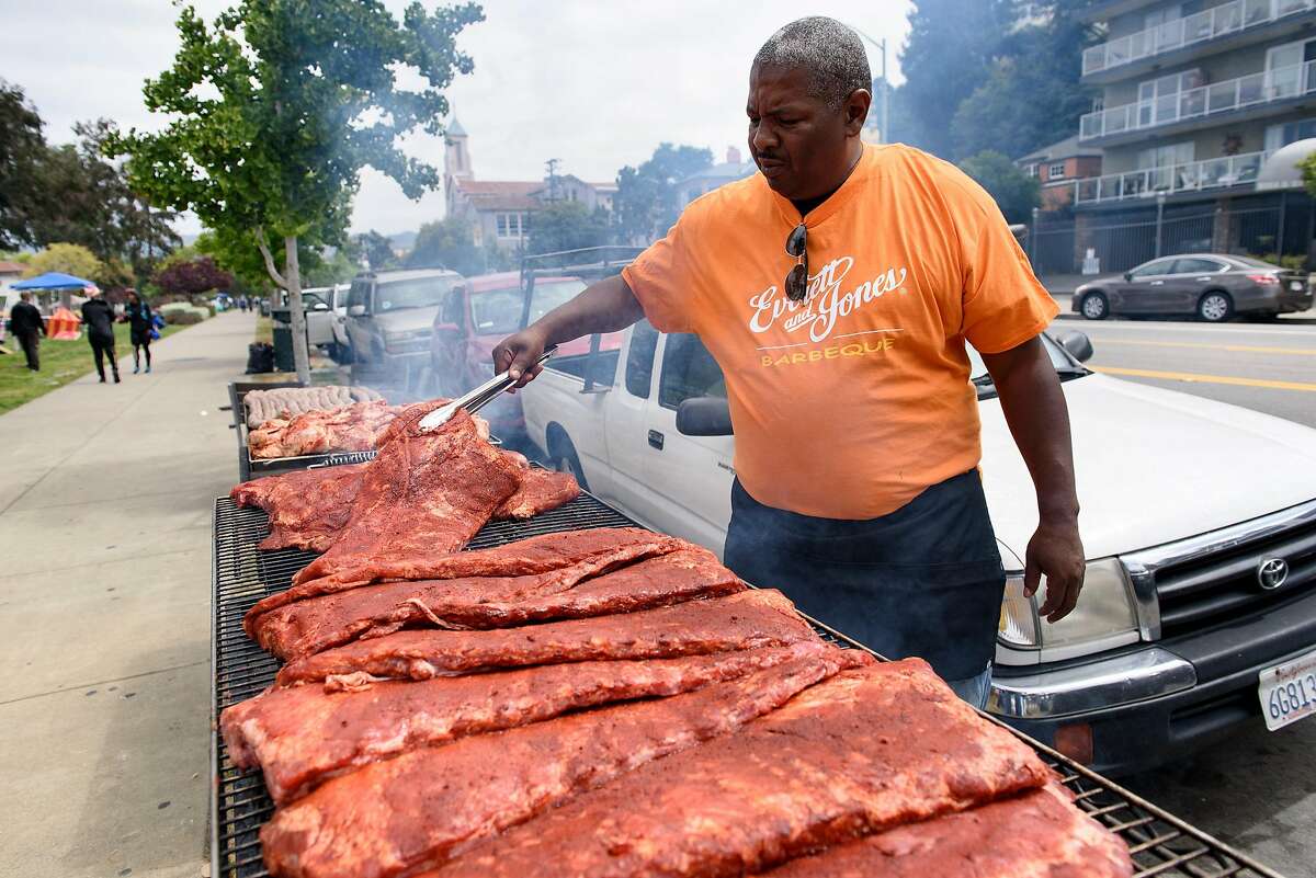 Lamont Payton of Everett and Jones BBQ tends to his grills during the "BBQ'n While Black" party at Lake Merritt in Oakland, CA, on Sunday May 20, 2018.