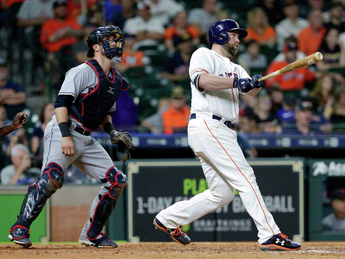 Houston Astros catcher Brian McCann (16) watches his two-run home run ball in front of Cleveland Indians catcher Yan Gomes during the seventh inning of a baseball game, Sunday, May 20, 2018, in Houston. (AP Photo/Michael Wyke)