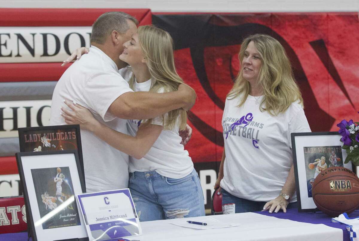 Jessica Hiltibrand hugs her father Daniel after signing to play basketball for Cornell College during a signing ceremony at Splendora High School on Thursday, May 17, 2018, in Splendora.