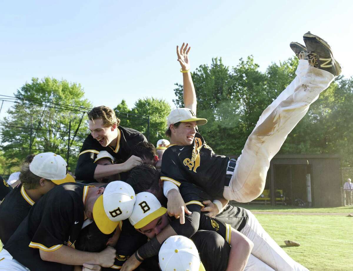 Brunswick centerfielder Marc McGuire, right, flips onto a pile of his teammates after the final out in Brunswick’s 4-3 win over Hopkins in the Fairchester Athletic Association baseball championship game on Monday in Greenwich.