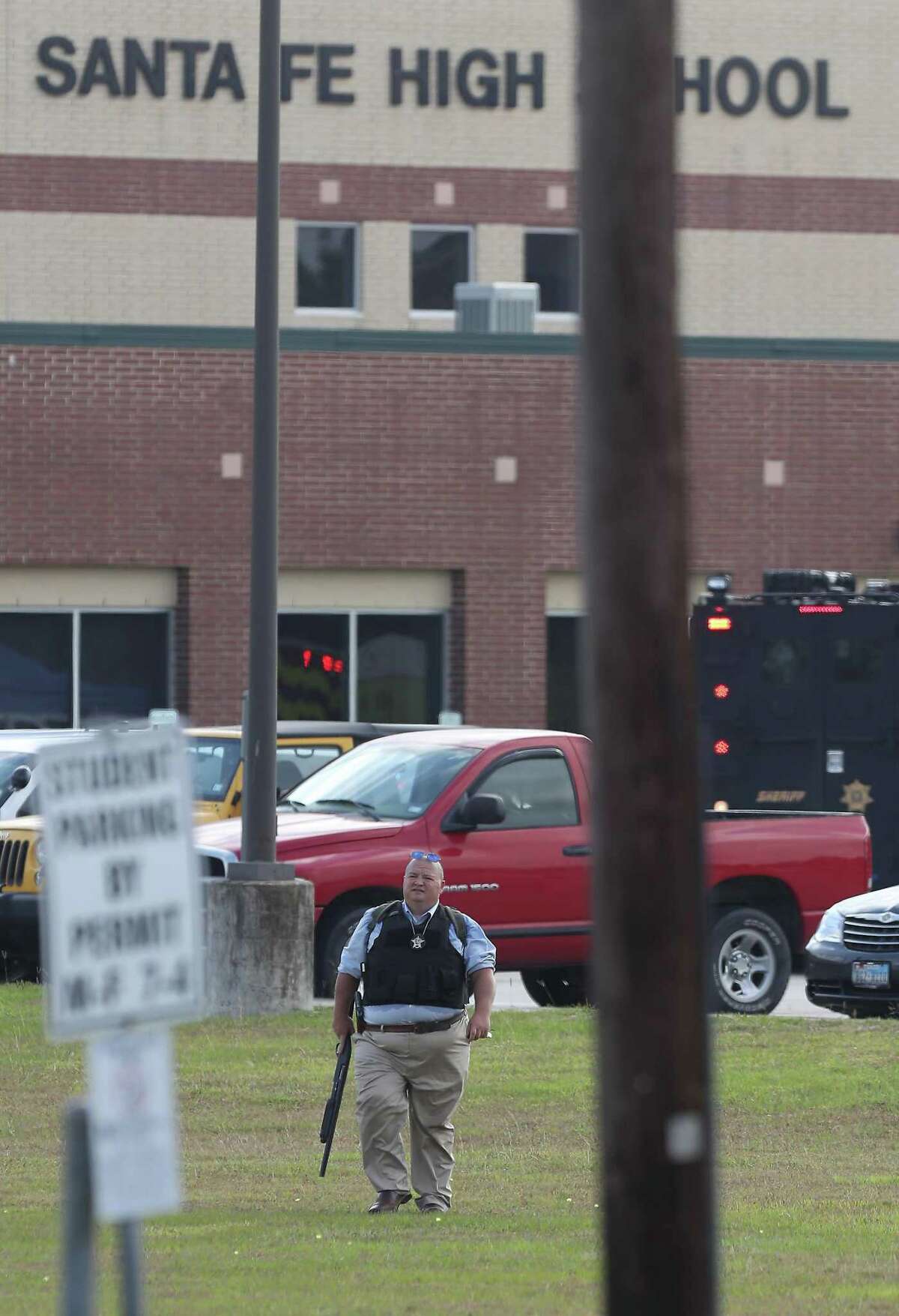 A law enforcement officer leaves Santa Fe High School in May 2018, when police say a student shot and killed 10 people at the campus. Many school districts have increased their police presence and safety measures at campuses in the wake of numerous school shootings in recent years.