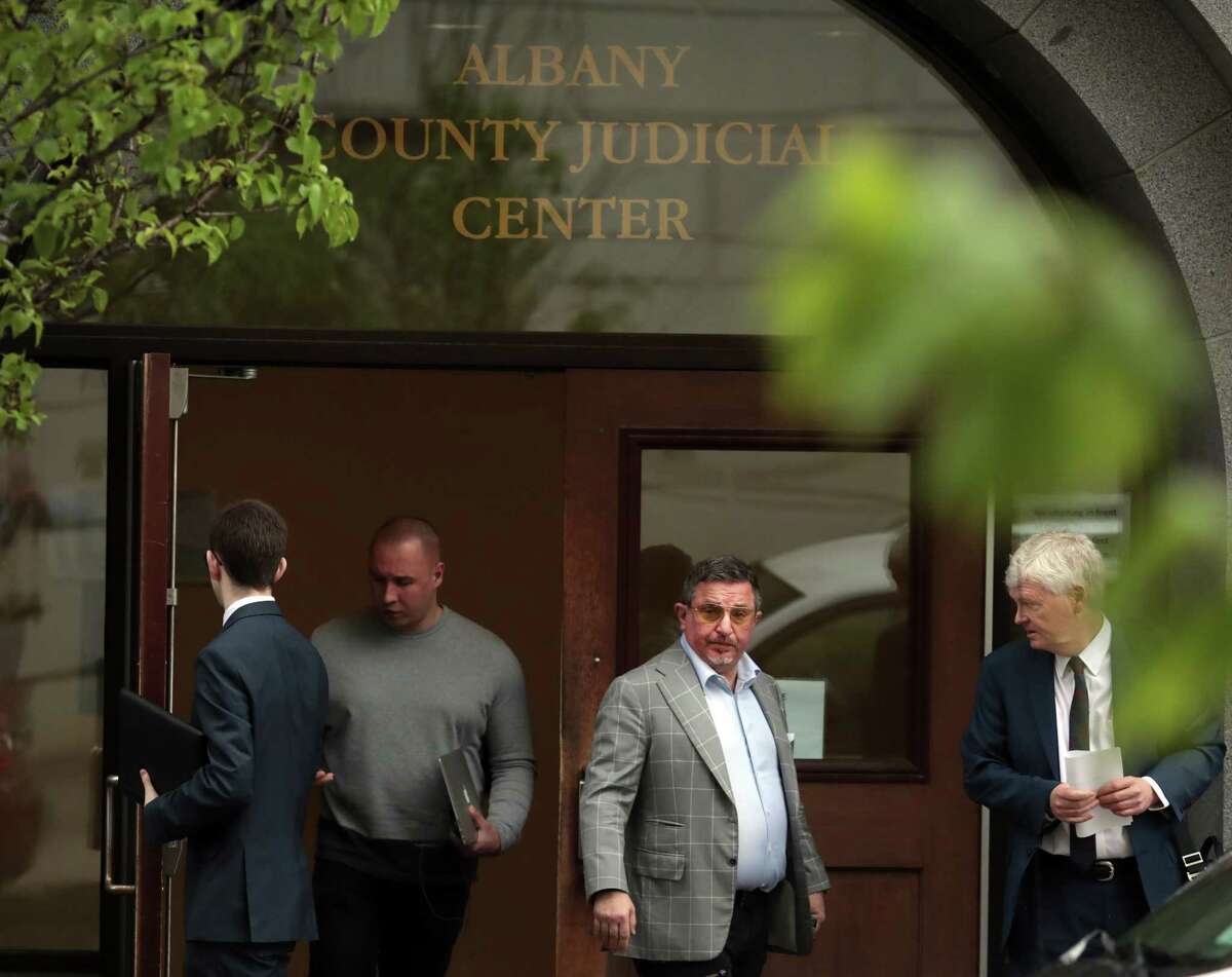 Evgeny Freidman, center, leaves court after pleading guilty and promising his cooperation in state and federal investigations, in Albany, N.Y., May 22, 2018. A significant business partner of Michael Cohen, President Trump’s personal lawyer, Freidman has quietly agreed to cooperate with the government as a potential witness, a development that could be used as leverage to pressure Cohen to work with the special counsel examining Russian interference in the 2016 presidential election.