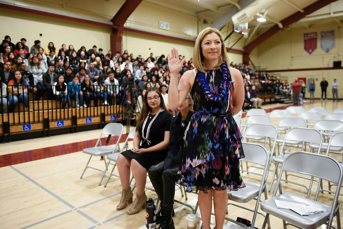 San Jose High School principal Gloria Marchant raises her hand as she is sworn in as a new US citizen during a naturalization ceremony held in the gym at San Jose High School in San Jose, CA, on Tuesday May 22, 2018.