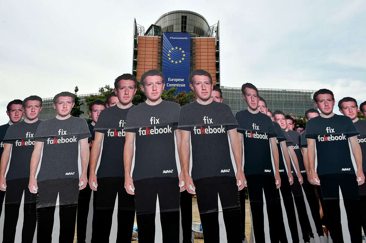 Global activists of Avaaz, set up cardboard cutouts of Facebook chief Mark Zuckerberg, on which is written "Fix Fakebook", in front of the European Union headquarters in Brussels, on May 22, 2018, as they call attention to what the groups says are hundreds of millions of fake accounts still spreading disinformation on Facebook. Advocacy group Avaaz is calling attention to what the groups says are hundreds of millions of fake accounts still spreading disinformation on Facebook. Facebook chief will say sorry to the European Parliament on May 22, 2018, pledging that the social media giant has learned hard lessons from a massive breach of users' personal data. Facebook admitted that up to 87 million users may have had their data hijacked by British consultancy Cambridge Analytica, which worked for US President Donald Trump during his 2016 campaign. / AFP PHOTO / JOHN THYSJOHN THYS/AFP/Getty Images