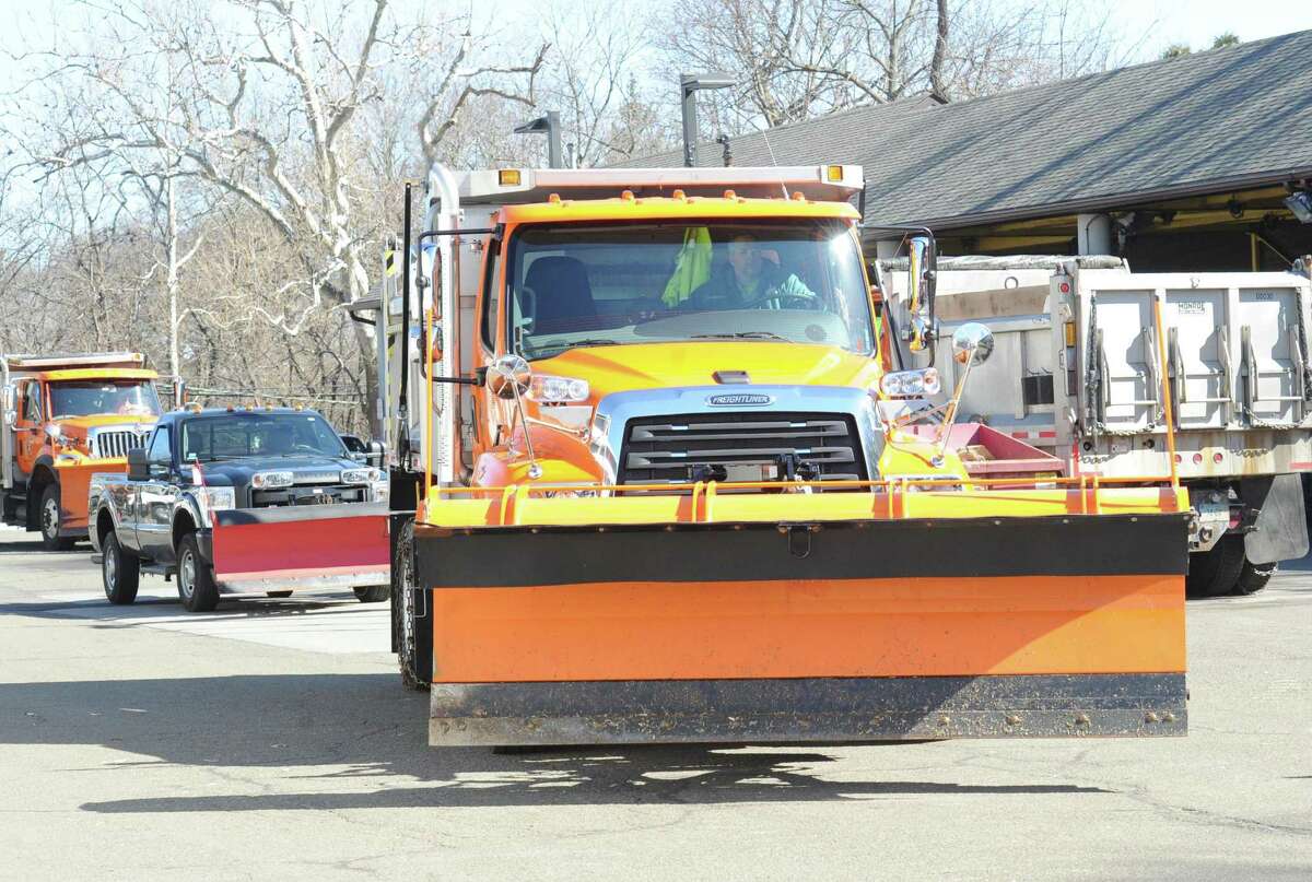 Greenwich Department of Public Works employees prepare vehicles in early March. The department is serving the town in a different way this week, by collecting donations for Neighbor to Neighbor.