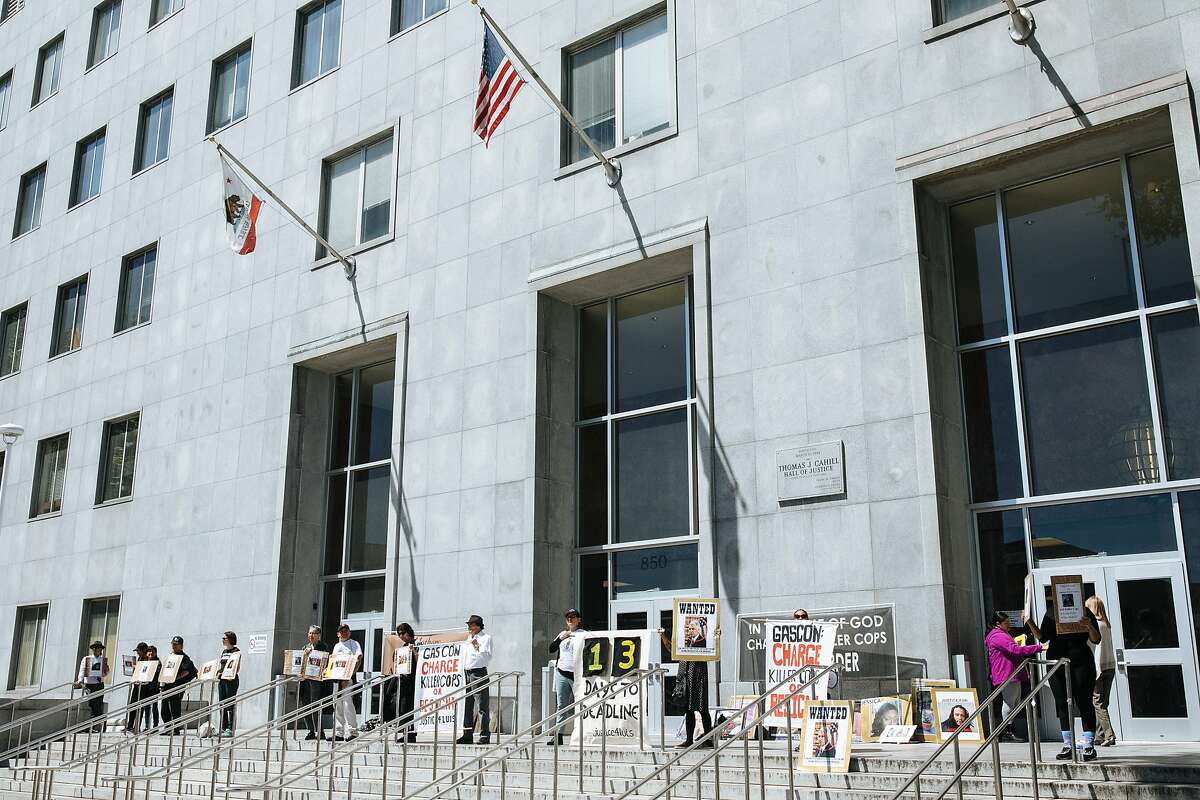 Protesters chant outside the Hall of Justice in protest of police shootings in San Francisco, Calif., Friday, April 13, 2018.