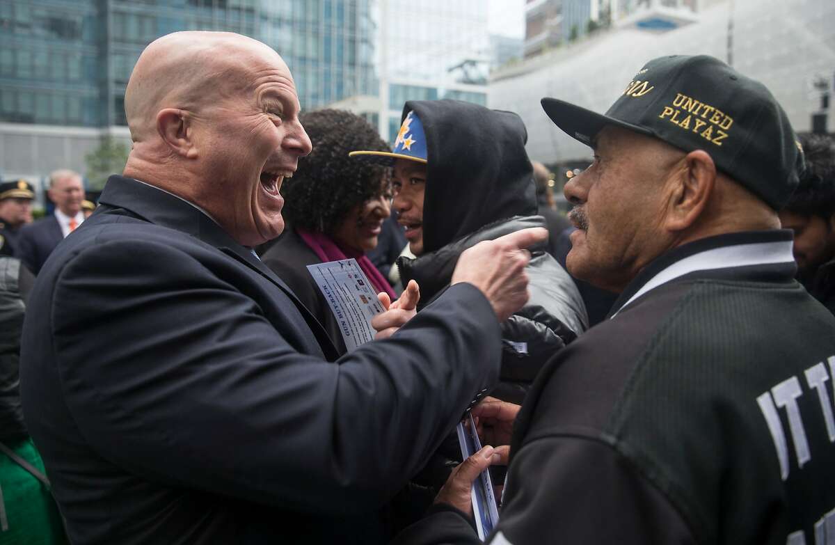 Former San Francisco Police Chief Greg Suhr greets members of the United Playaz during the grand opening ceremony of the Salesforce Tower in San Francisco, Calif. Tuesday, May 22, 2018.