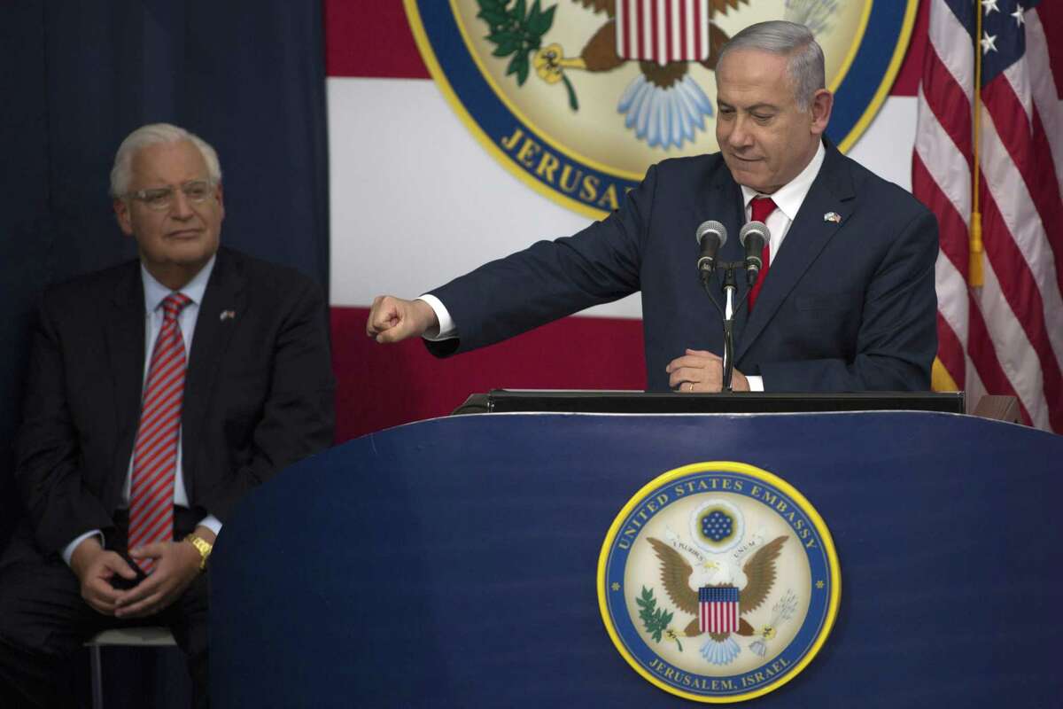 Israel's Prime Minister Benjamin Netanyahu speaks on stage as U.S. ambassador to Israel David Friedman (L) looks on during the opening of the US embassy in Jerusalem on May 14, 2018 in Jerusalem, Israel. US President Donald J. Trump's administration officially transfered the ambassador's offices to the consulate building and temporarily use it as the new US Embassy in Jerusalem. Trump in December last year recognized Jerusalem as Israel's capital and announced an embassy move from Tel Aviv, prompting protests in the occupied Palestinian territories and several Muslim-majority countries.
