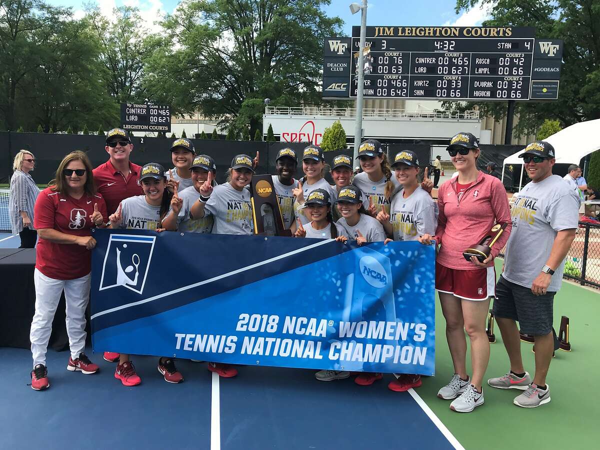 Stanford players and coaches pose with the championship banner after winning the school's 19th women's NCAA tennis title in Winston-Salem, N.C., on Tuesday.