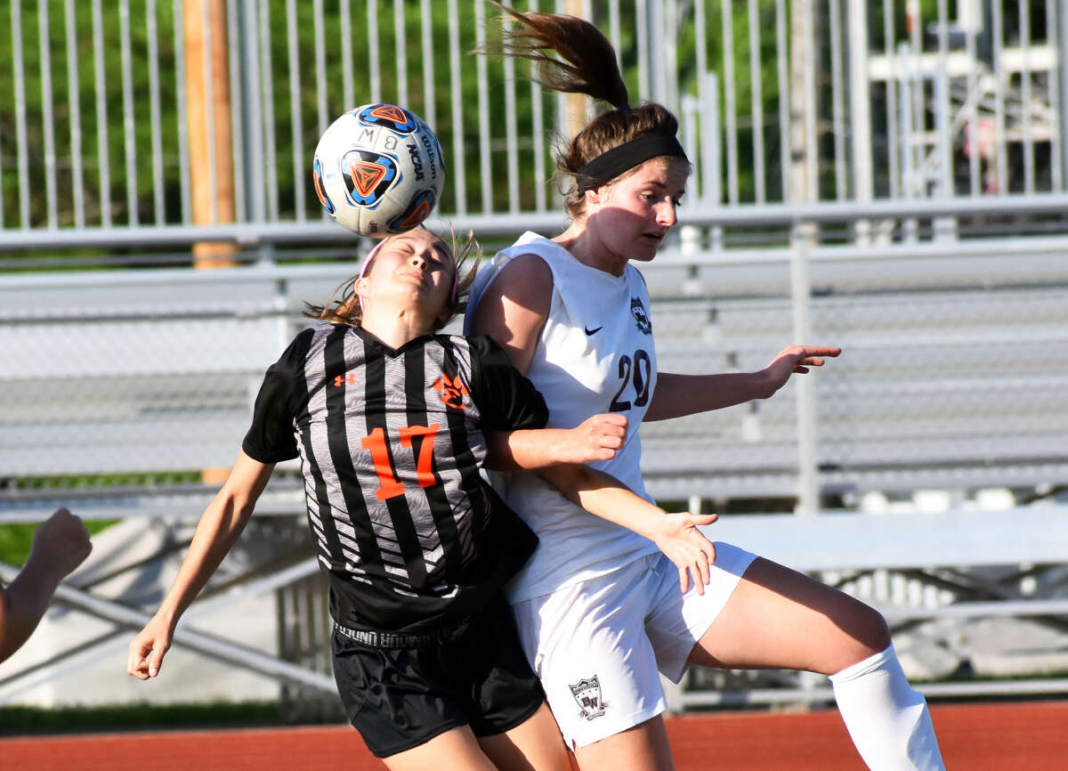 Edwardsville’s Megan Bowman, left, and Belleville West’s Melanie Kulig battle for a ball in the first half of Tuesday’s game.