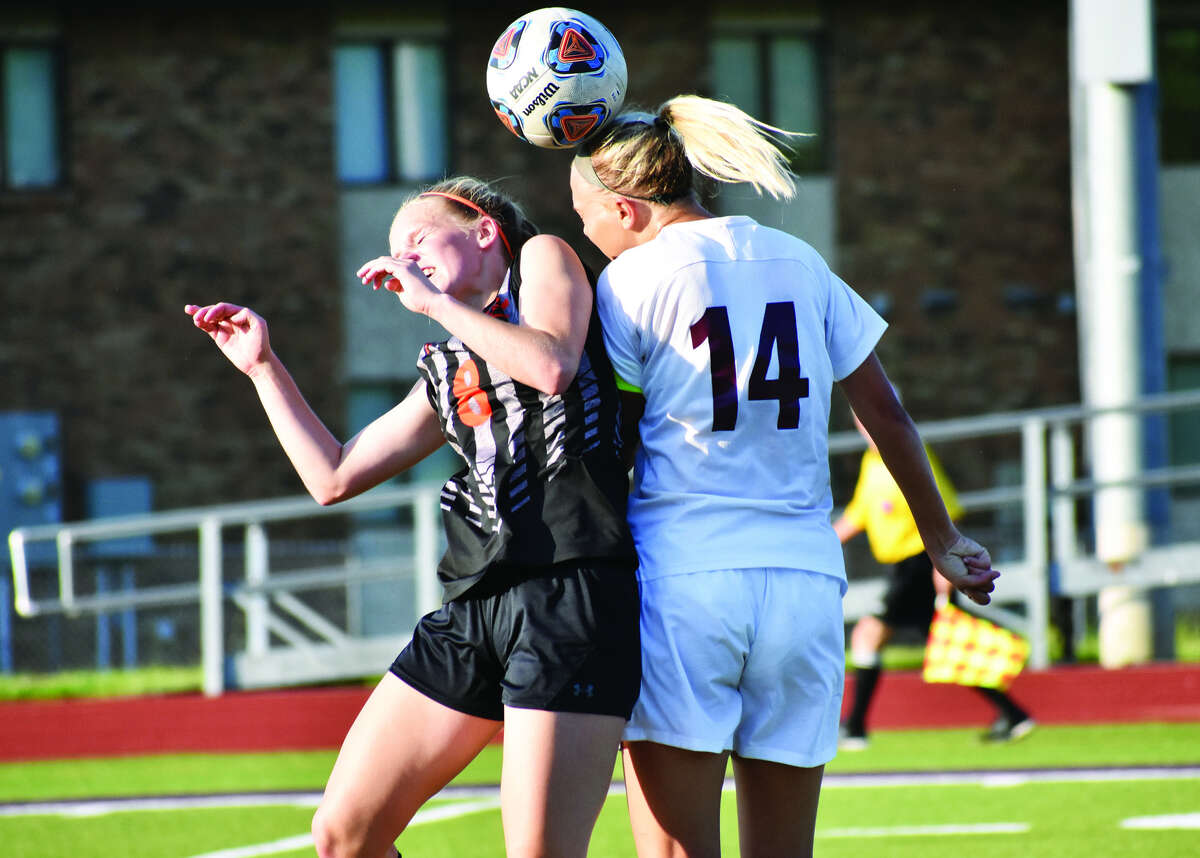 Edwardsville defender Sarah Kraus, left, goes up for a 50-50 ball against Belleville West’s Taylor Mathenia during first-half action at Leemon Field on the campus of McKendree University in Lebanon.