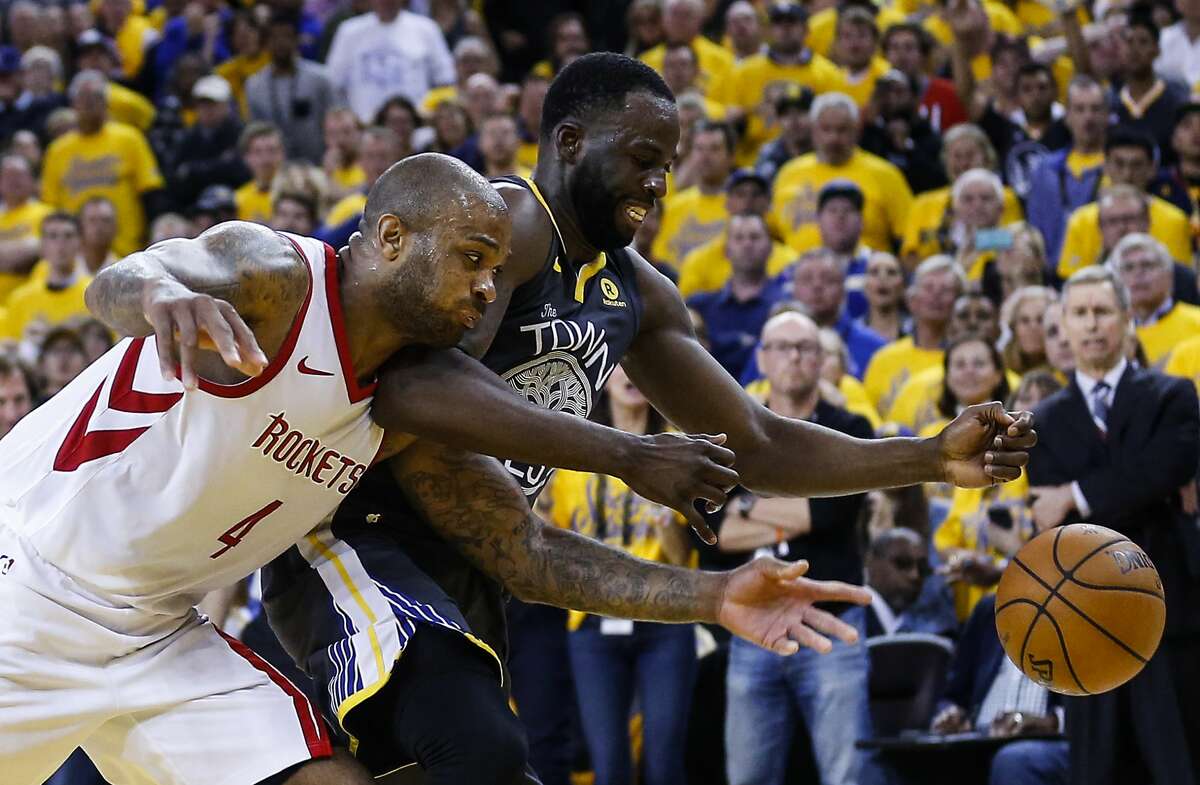 Houston Rockets forward PJ Tucker (4) and Golden State Warriors forward Draymond Green (23) go after a loose ball during the second half of Game 4 of the Western Conference Finals at Oracle Arena Tuesday, May 22, 2018 in Oakland. (Michael Ciaglo / Houston Chronicle)