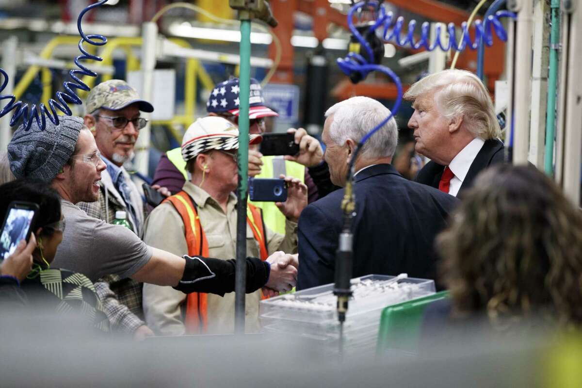 Then President-elect Donald Trump and Vice President-elect Mike Pence visit an Indianapolis plant of United Technologies division Carrier, in December 2016. Trump had made UTC’s plan to move jobs to Mexico part of his campaign appeal to save U.S. jobs when elected. (AP Photo/Evan Vucci)