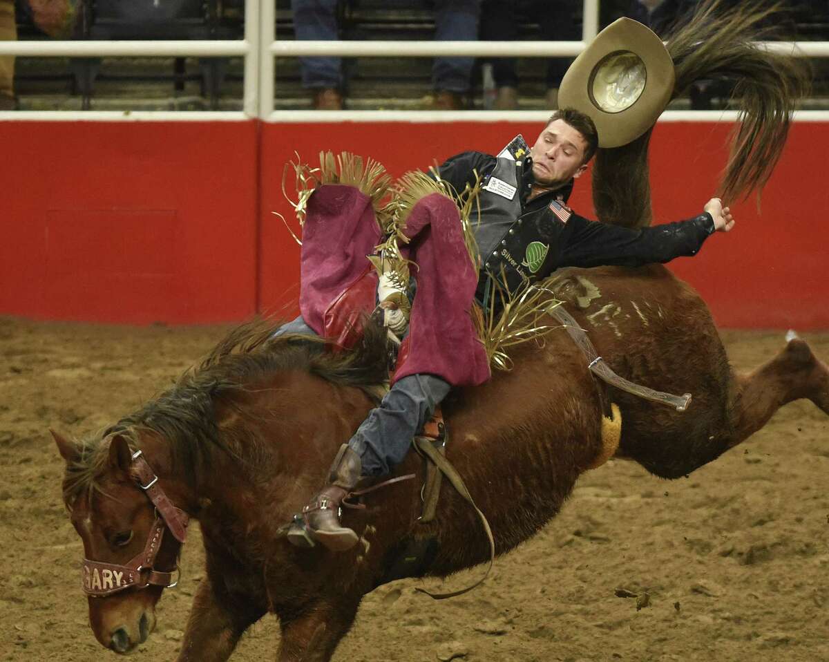 Caleb Bennett hangs on to win the bareback riding competition during the finals of the San Antonio Stock Show & Rodeo in the AT&T Center on Saturday, Feb. 24, 2018.