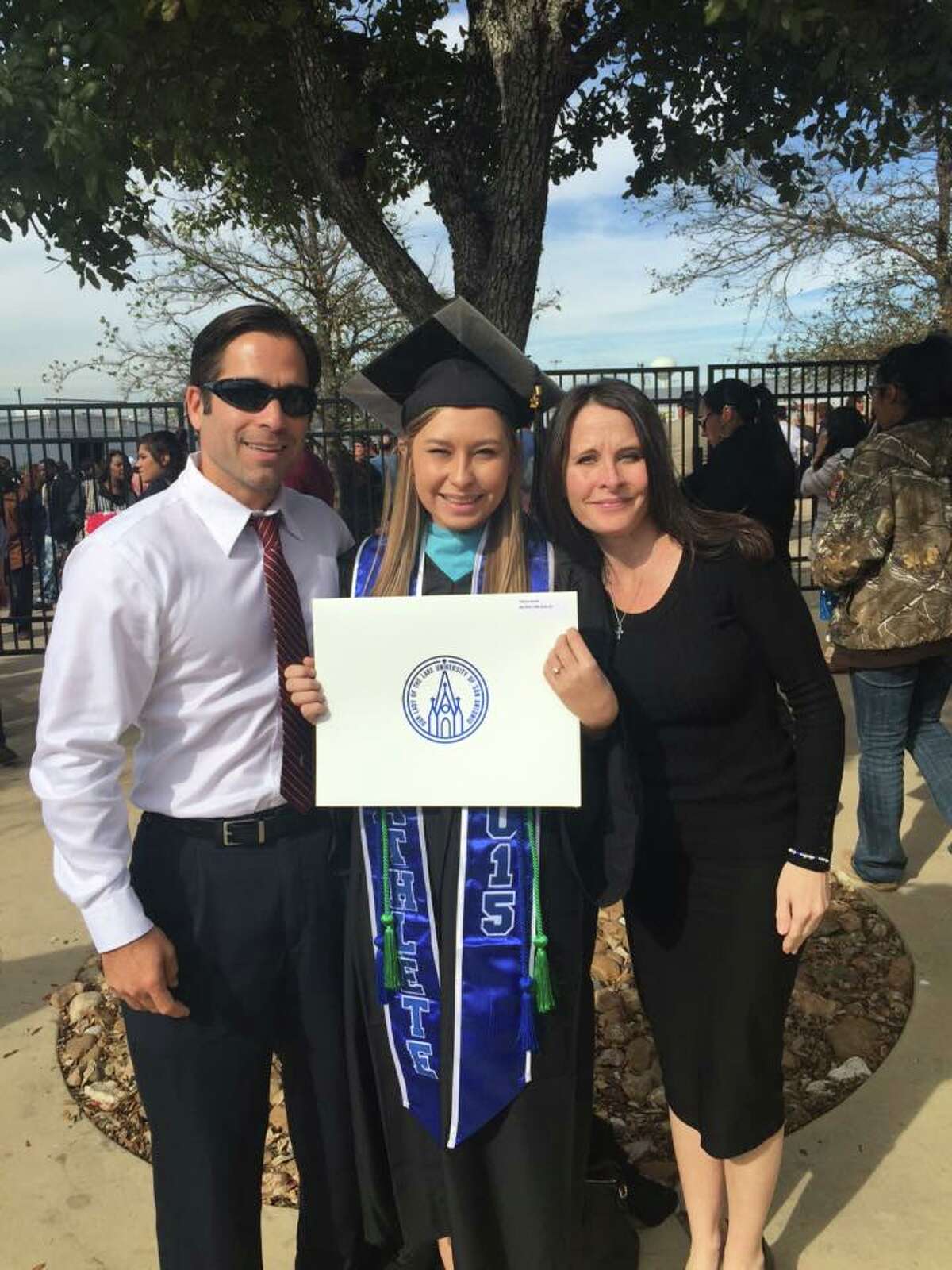 Hailey Reyes poses for a photo with her parents after graduating from Our Lady of the Lake University with a bachelor's degree in psychology.
