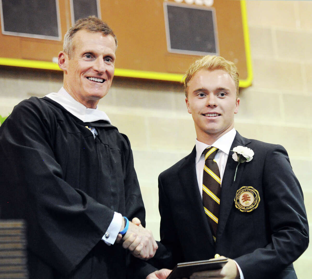 Brunswick School Headmaster Tom Philip, left, shakes hands with Charlie Berger, after handing Berger his diploma during the Brunswick School commencement in the Dann Gymnasium at the school in Greenwich, Conn., Wednesday, May 23, 2018. Berger said he will be attending Southern Methodist University in the fall and was one of Ninety-nine students that graduated from Brunswick.