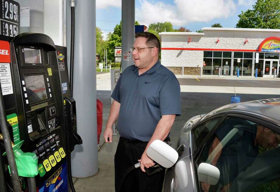 Dan Dmyszewicz pumps gas at the APlus Sunoco station off Northway Exit 8 Wednesday May 23, 2018 in Clifton Park, NY. Undaunted by rising gas prices, Dmyszewicz is planning a family road trip to North Carolina for the holiday. (John Carl D'Annibale/Times Union) Photo: John Carl D'Annibale / 20043858A