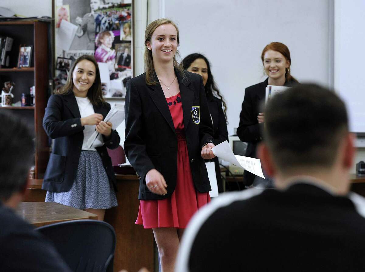 Members of the Danbury High School DECA team, from leftCatarina Silva, 17, Caitlin Ansel 18, Amandha DeSouza, 18 and Courtney Capozzi, 17, give a presentation about Danbury High school and its new addition to local Realtors for what they're calling Realtor Day, Wednesday, May 23, 2018.