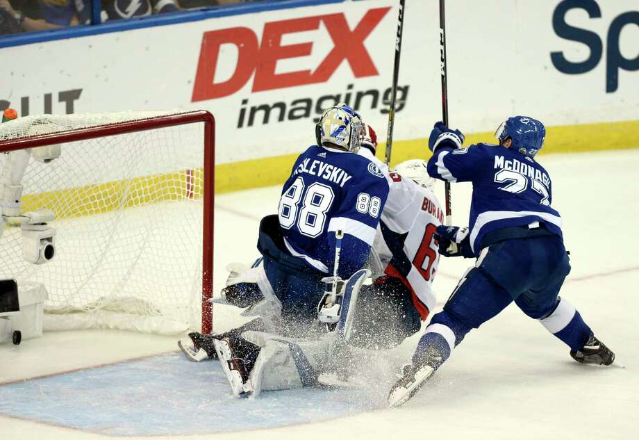 Washington Capitals left wing Andre Burakovsky, center, scores a goal past Tampa Bay Lightning goaltender Andrei Vasilevskiy (88) and defenseman Ryan McDonagh, right, during the second period of Game 7 of the NHL Eastern Conference finals hockey playoff series Wednesday, May 23, 2018, in Tampa, Fla. (AP Photo/Jason Behnken) Photo: Jason Behnken / FR171457 AP